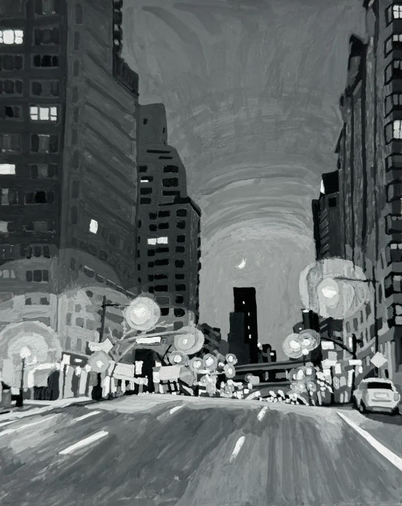 Black and white city street at night.