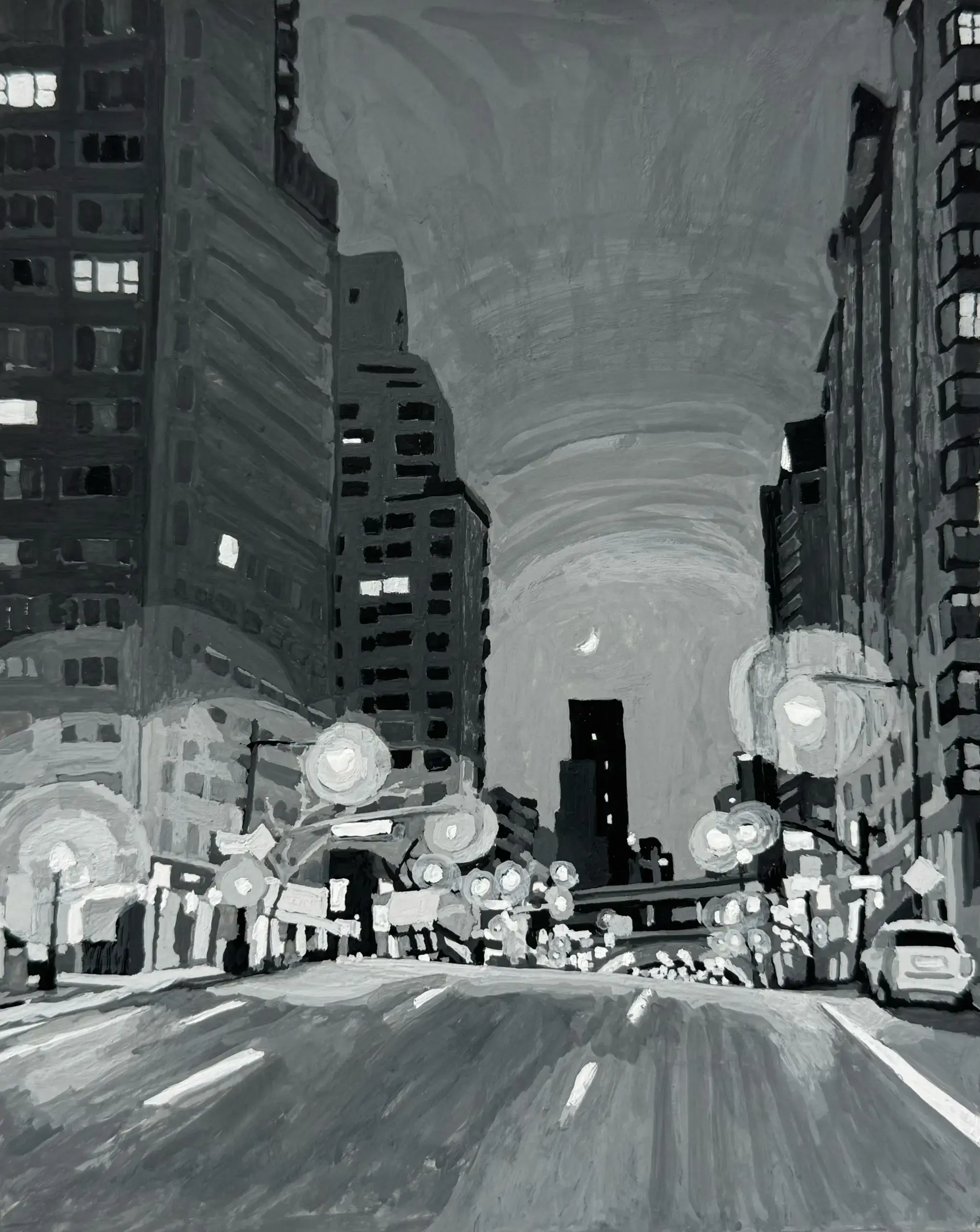 Black and white city street at night.